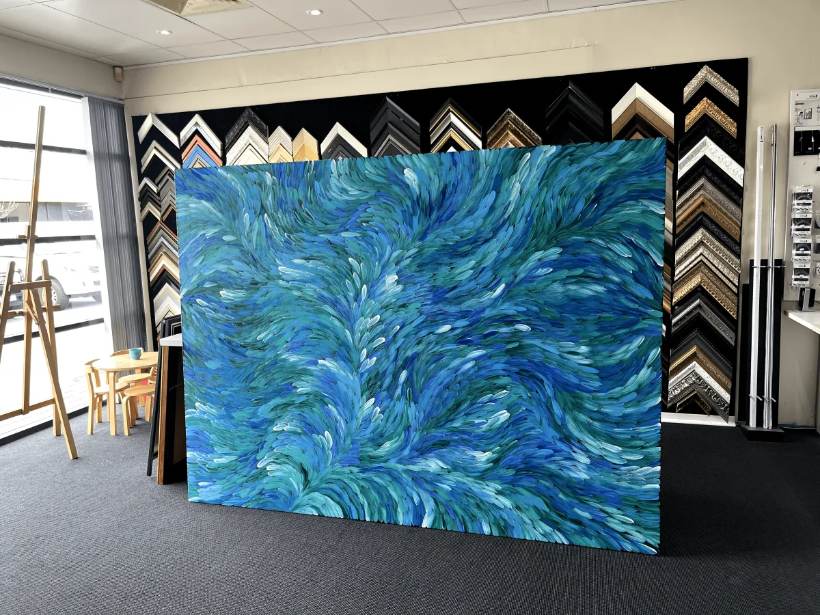 Large blue canvas stretched in the showroom