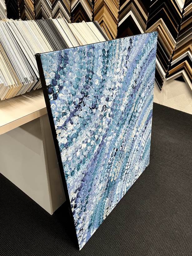 Side view of a stretched canvas showing the tight, even edge