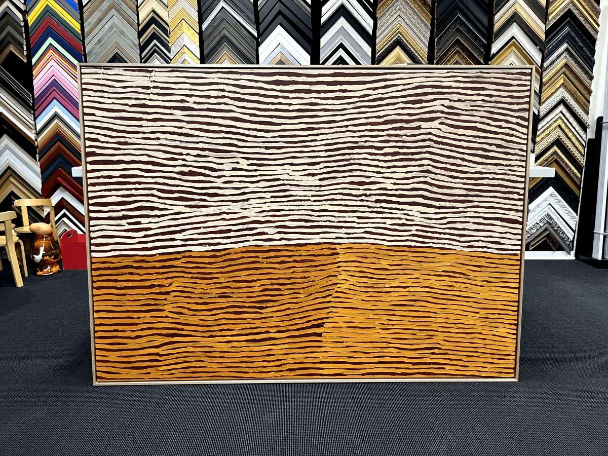 Large stretched canvas in front of the moulding wall