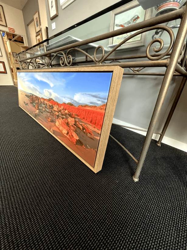 Landscape canvas in an oak float frame, seen side on