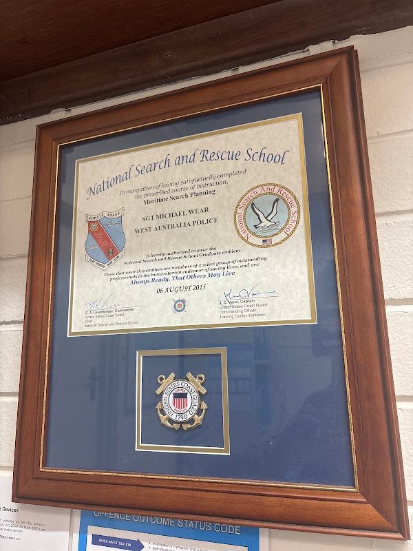 Certificate and coin framed with a navy mat