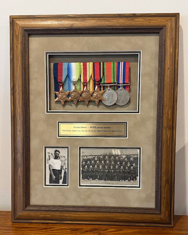 Medals and photos in a timber shadow box